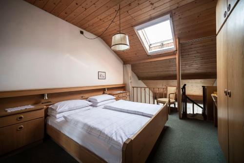a bedroom with a large bed and a window at Post Residence in San Candido