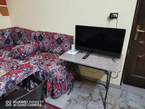 a computer sitting on a table next to a couch at King Nubian House in Aswan