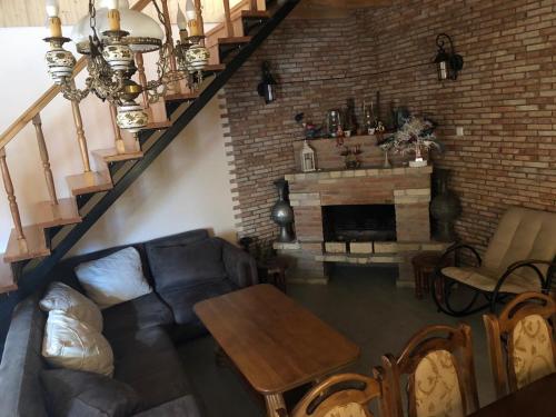 a living room with a couch and a fireplace at Cozy Place in Kazbegi in Stepantsminda