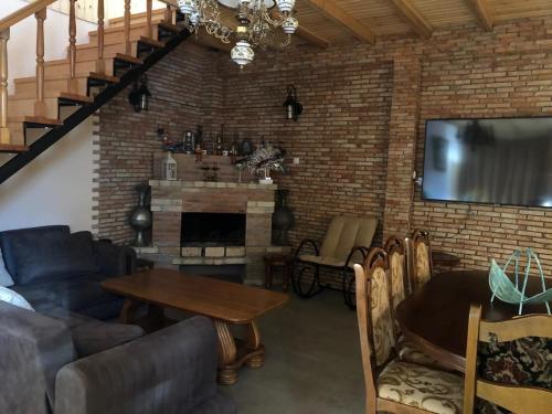 a living room with a couch and a fireplace at Cozy Place in Kazbegi in Stepantsminda
