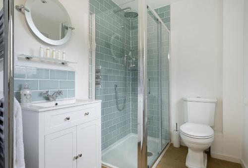 a bathroom with a shower and a toilet and a sink at Fairfields in Moreton in Marsh