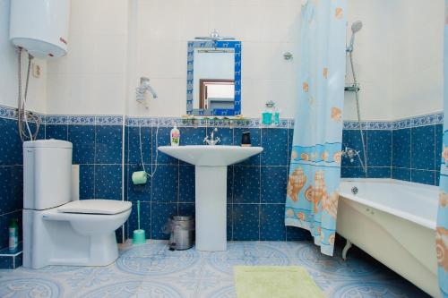 a bathroom with a sink and a toilet and a tub at Style Hotel in Lipetsk