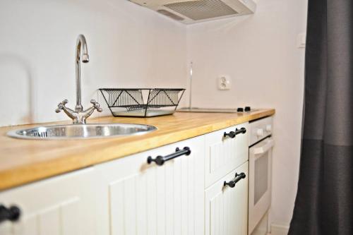 a kitchen with a sink and a counter top at White Sand Apartment Centrum by Grand Apartments in Sopot