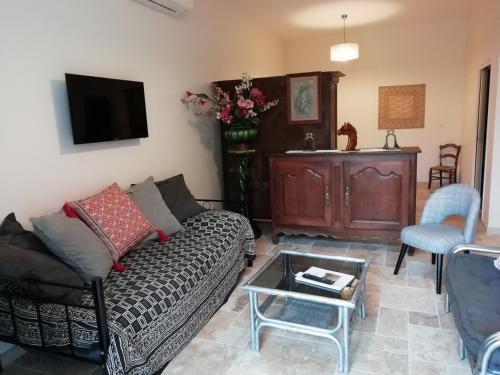 a living room with a couch and a coffee table at Domaine de la Vidalle in Vendres