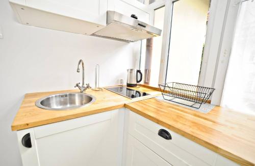 a kitchen with a sink and a counter top at White Marina Apartment by Grand Apartments in Sopot
