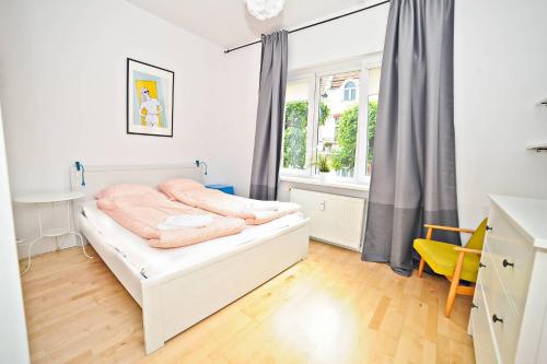 a bedroom with a bed and a window at White Marina Apartment by Grand Apartments in Sopot