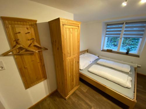 a small bedroom with a bed and a window at Ferienhaus Kaufmanns Cafe in Kurort Oberwiesenthal