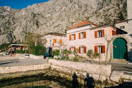 a group of buildings in front of a mountain at Casa Pasinovic in Kotor