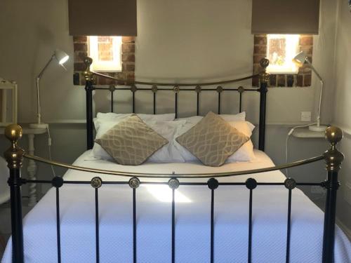 a bed with two pillows on it in a bedroom at The Admiral Hornblower in Oakham