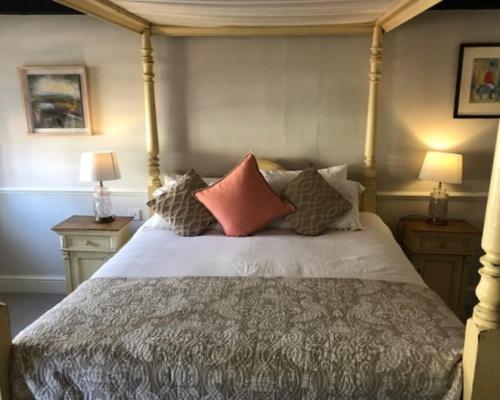a bedroom with a bed with pillows on it at The Admiral Hornblower in Oakham