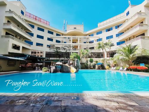 a swimming pool in front of a building at Sea & Wave #1 Coral Bay Apartment in Pangkor