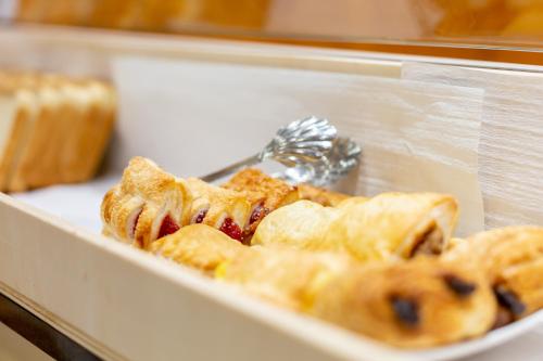 a bunch of pastries in a display case at Hotel Alexander in Basel