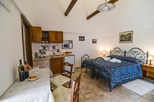 a kitchen and a bedroom with a bed in a room at Truddhi Casa e Cucina di Puglia in Locorotondo