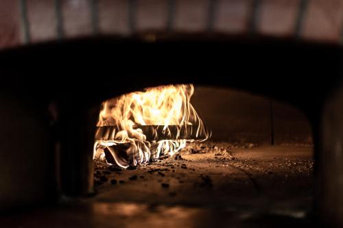 a fire is burning in a brick oven at Gasthof Bären in Hasliberg