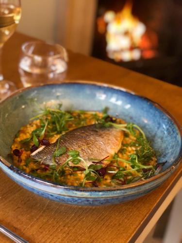 a blue bowl of food on a table at The Admiral Hornblower in Oakham