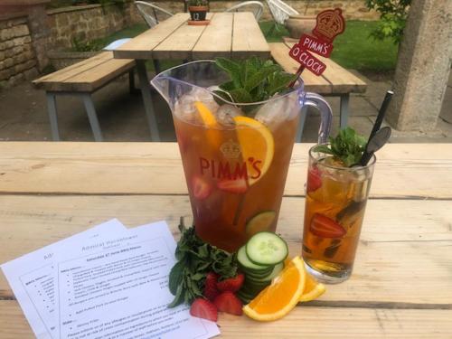a table with two glasses of juice and fruit at The Admiral Hornblower in Oakham
