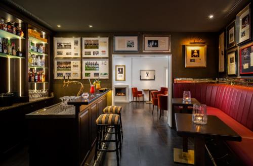a restaurant with a bar and some tables and chairs at Hotel zur Post Riesenbeck in Riesenbeck