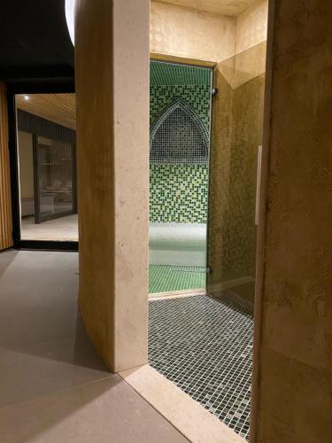 a glass door to a shower in a building at ETER Hotel in Golem