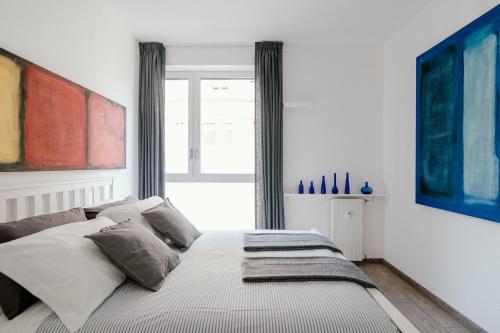 a bedroom with a large bed in front of a window at Mark's Gallery Apartment by MyHomeInComo in Como