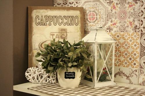 a plant in a vase on a table with a sign at Ankon Hotel in Ancona