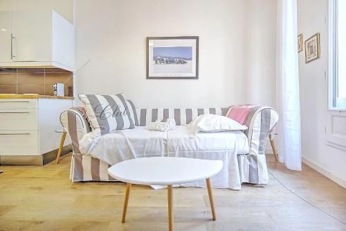 un salon avec un canapé et une table dans l'établissement Cannes Carré d'Or Cozy 1 BR balcony, Croisette Palais 2 mn by Olam Properties, à Cannes