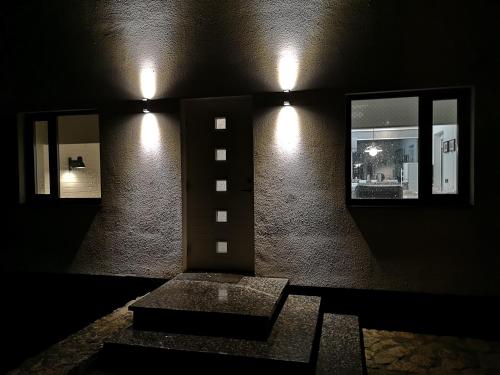 a dark room with two lights on the wall at Villa Gauja - holiday home close to the sea and lake in Gauja