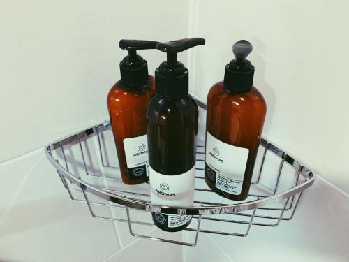 a wire rack with three bottles of liquid at Hacienda Escondida 10min to Airport in Alajuela City