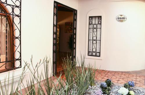 a front door of a house with plants in front at Hacienda Escondida 10min to Airport in Alajuela City