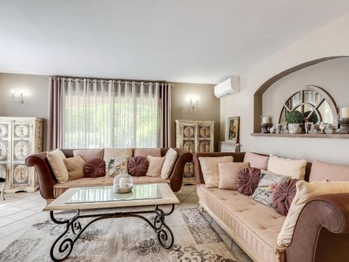 a living room with two couches and a coffee table at Holiday Home Villa Souleyas by Interhome in Sainte-Maxime