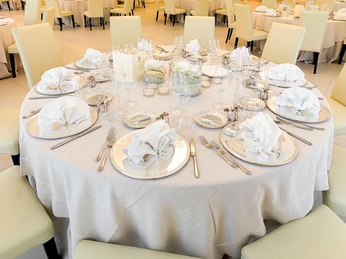a white table with silverware and napkins on it at Il Castagneto Hotel in Melfi