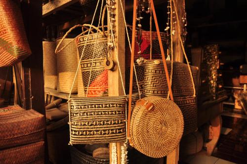a group of baskets are hanging on a shelf at Mu Homestay in Tetebatu