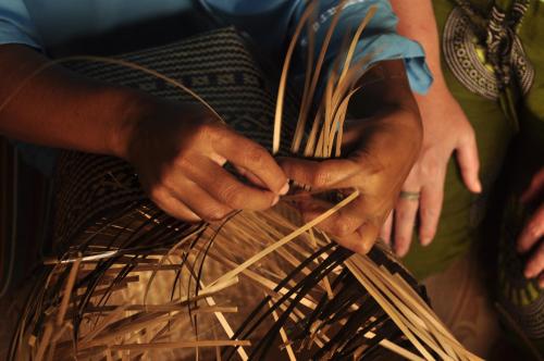 a person is holding a bunch of hay at Mu Homestay in Tetebatu