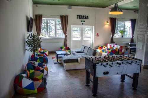a living room with a foosball table in the middle at Ubytovňa Milex in Nové Mesto nad Váhom