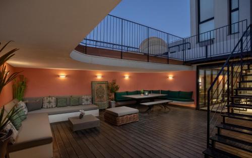a living room with a couch and a table at Penthouse 3BR near Rothschild bd by HolyGuest in Tel Aviv
