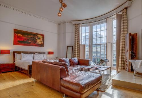 a living room filled with furniture and a window at Hotel Una in Brighton & Hove
