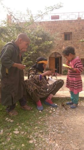 a man and two children standing next to a woman at Auberge Le Festival Todra Gorge in Aït Baha