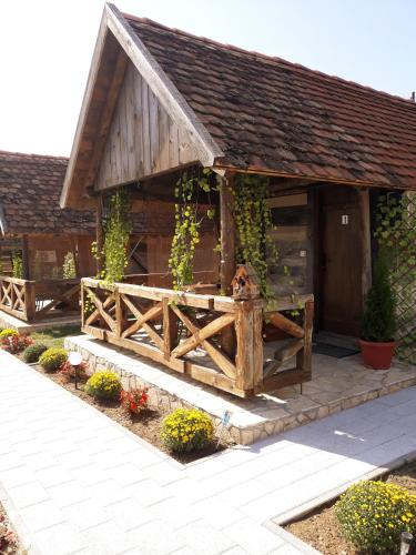a wooden building with a gate and a fence at Etno selo EDEN in Žeravački Potok