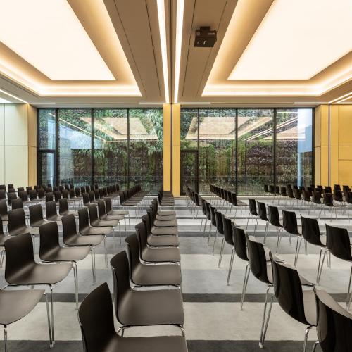 an empty lecture hall with rows of chairs at Lux Lisboa Park in Lisbon