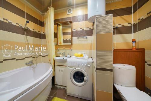a bathroom with a washing machine and a sink at PaulMarie Apartments on Shahterov in Salihorsk