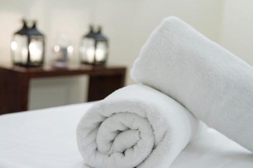 a white towel sitting on top of a bed at Sofitel Buenos Aires Recoleta in Buenos Aires