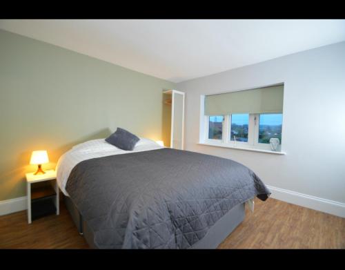 a bedroom with a bed and a window at The Plough Retreat in Coddington