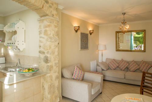 a kitchen and a living room with a couch at La Vista de Medina Studios & Apartments in Medina Sidonia