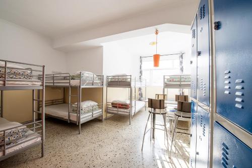 a room with four bunk beds and a window at Safestay Athens Monastiraki in Athens