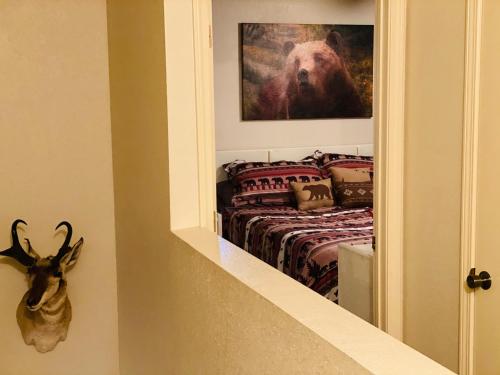 a bedroom with a bed with a picture of a bear at 2BR Gated Escape With A Pool And Walk to Dining and Trails in Pinetop-Lakeside