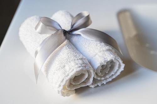 a towel with a silver bow on a table at Marcus Suite in Cagliari
