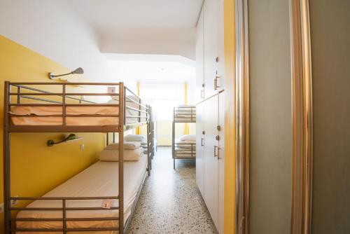 a hallway with bunk beds in a room at Safestay Athens Monastiraki in Athens