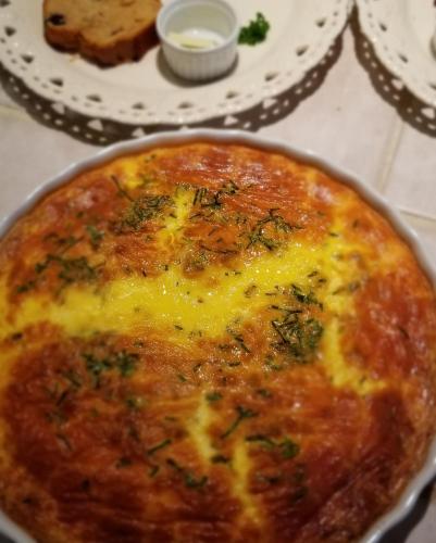a cheese pizza in a pan on a table at Timbercliffe Cottage Inn in Camden