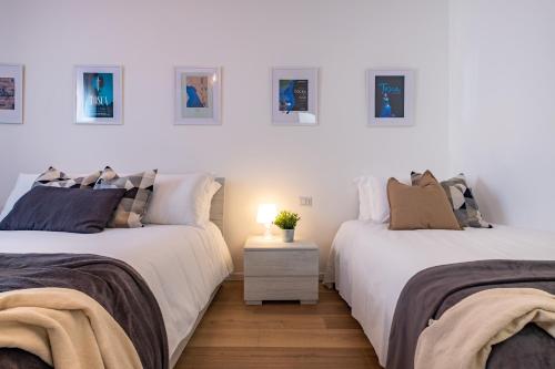 due letti uno accanto all'altro in una stanza di Opera & expo Verona - Tosca a Verona