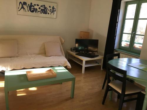 - un salon avec un lit et une table avec un livre dans l'établissement allees des soupirs, à Cahors