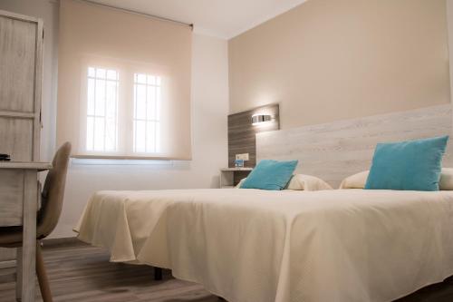 Katil atau katil-katil dalam bilik di Hostal Restaurante el Cary